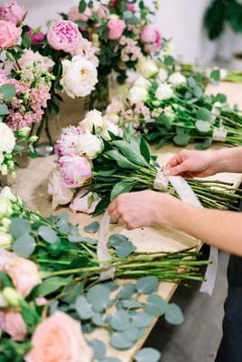 Florist tying a wedding bouquet