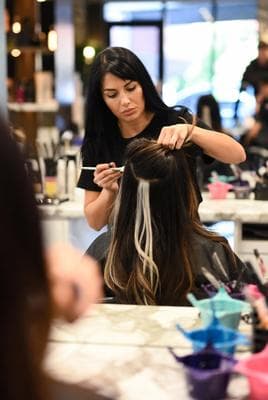 Hairdresser applying balayage